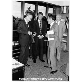 Visiting Professor Norton Bedford of University of Illinois, being presented with David Syme tie and coaster set, with him are Laurie Webb, John Onto and Noel Huggan of Chisholm Business School