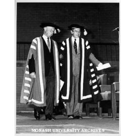 Professor Ray Martin (right) accompanying Sir George Lush to Chancellor's chair for installation ceremony