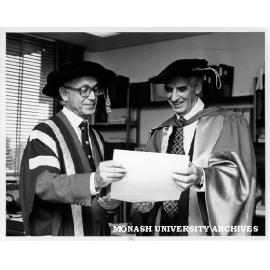 Deputy Chancellor Dr Joe Isaac (left) presenting Emeritus Professor Don Cochrane with honorary Doctor of Economics
