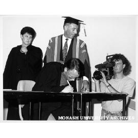 Signing of Monash-GIAE Affiliation agreement. Student representative Mr Peter Shacklock (president of Gippsland Institute Union), Mr Tony Pritchard, Ms Jenny Hill looking on