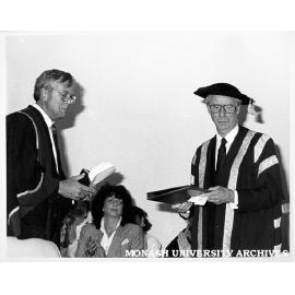 Exchange of Monash-GIAE Affiliation documents. Deputy Chancellor Mr Arnold Hancock (right) and Mr Crofton Hatsell, President of the Council of Gippsland Institute