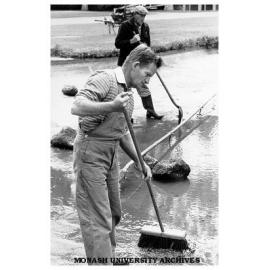 Groundsman Bernie Eccles cleaning pond in forum