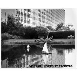 Model yachts on pond with Menzies building in background