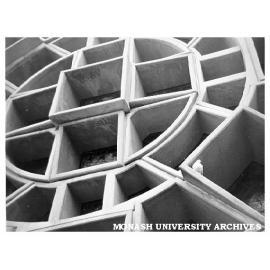 West window, Robert Blackwood Hall with pigeon at rest in the concrete frames