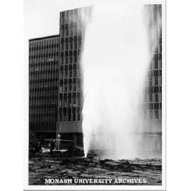 Broken water main at site of multidisciplinary centre with Menzies building in background