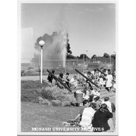 Students outside Law School and broken water main in background