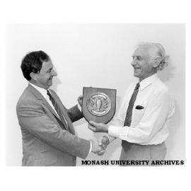 Professor Kevin Westfold presenting cricket trophy to Mr Peter Wade (left) after Comptroller's-versus- Registrar's Westfold memorial cricket match