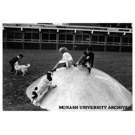 Children playing in Science courtyard on one of Clive Murray-White's 'Domes'.