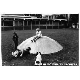 Children playing in Science courtyard on one of Clive Murray-White's 'Domes'.