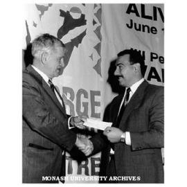 Deputy Vice-Chancellor Professor Geoff Vaughan (left) accepting cheques from Mr Peter Manachetti, Store Manager, Myer Frankston, at inaugural theatre season at George Jenkins Theatre, Frankston campus