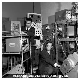 Drs M. Spaeth (left) and John Pilbrow with physics equipment
