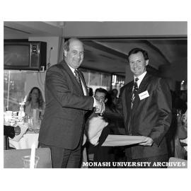 Antony Edwards (right) receiving the Mayne Nickless Award in marketing from Peter Cowley