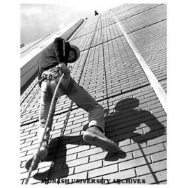 Third year science student Peter Brenton abseiling down library wall during Open Day
