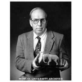 Professor Roger Short holds a model of an African elephant