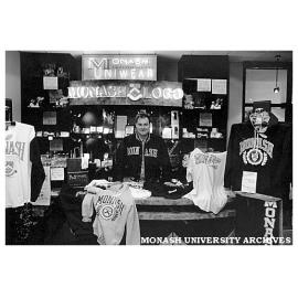 Union retailer controller, Mr Murray Pearce, shows some of the Monash clothing range in the Monash Shop at Clayton