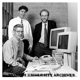 Monash publishing staff senior publications officer Mr Tim Mansour (seated), publications officer Mr Anthony Lynch (standing left) and manager Mr John Wilkins
