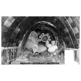 Pottery being placed inside an anagama kiln