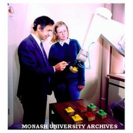 Gippsland senior lecturer Ibrahim Yousef demonstrates robotic arm to Engineering student