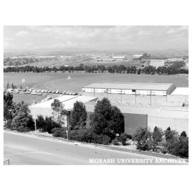 Monash Sports Centre and playing fields with Village drive-in in background