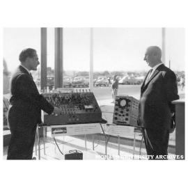 Electronic display at Commonwealth Technical Training Week exhibition at Chadstone shopping centre. D. Mills (left) and Mark Beresford.
