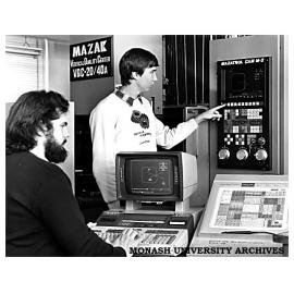 Fourth-year engineering students John Simmons (at keyboard) and Bruce Olsson demonstrate a direct link between CAD and CAM units