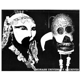 Two masked dancers at the opening of the ceramics installation The Changing Environment at the State Bank Galleria