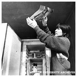Japanese glass artist Kazuko Eguchi examining a newly fired piece of work