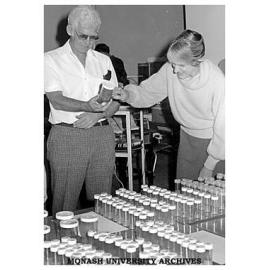 Dr Ron De Fossard checking plant tissue culture samples with a participant in his workshop on micro-propogation