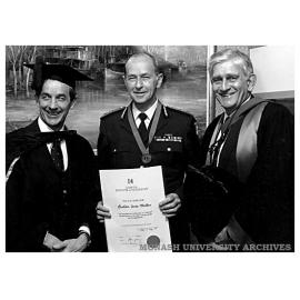 Chief Commissioner Miller (centre) receives his award of a Fellowship of Chisholm Institute. He is pictured with Dr Lionel Ward, President of Council (left) and Chisholm Director Dr Geoff Vaughan
