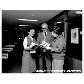 Rare books librarian Susan Radvansky (left), Lindsay Shaw and Brenda Niall perusing books in the exhibition 'Seven Little Billabongs'