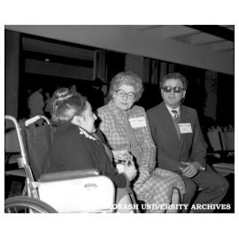 Associate Professor Lawrence McCredie (from right) talking to Dr Pat Hutson and Monash graduate Sue Shaw at equality of disabled people symposium