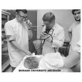 Dr Jack Hansky (right) uses an endoscope to examine a duodenal ulcer with Dr Graham Schmidt (centre)