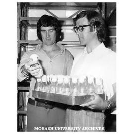PhD student Peter Hanna (left) and Dr Ken Dyer with bottles of 'superflies' mutated to withstand massive doses of organoposphate insecticides