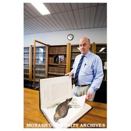 Rare Books Librarian Richard Overell, with a hand-coloured engraving of a wedge-tailed eagle from John Gould's book 'Birds of Australia'