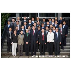 Delegation from Sichuan University, including two vice-presidents and all 35 deans, with Professor Richard Larkins on the steps of the Administration building