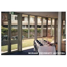 Interior of Monash University Club with outdoor eating area and Building 3d in background