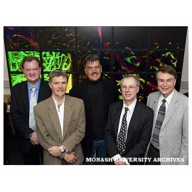 Professor Paul Bonnington, Dr Ian Harper, Associate Professor Martin Lackmann, Professor David Abramson and Professor Larry Smarr in front of the OptiPortal wall at Monash Micro Imaging.