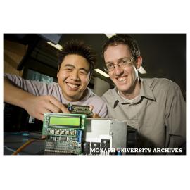 Engineering students Mr John Luo (left), and Mr Chris Beckett with two models of a prototype power inverter.