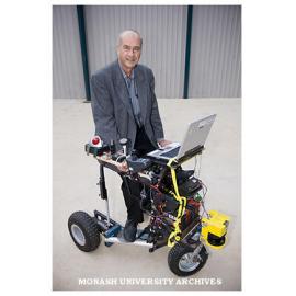 Professor Ray Jarvis, from Electrical and Computer Systems Engineering, with prototype motorised walk-chair.