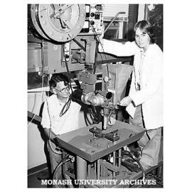 Gillian Heintze conducting an experiment on a large-scale welding rig, with Associate Professor Reg McPherson.