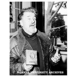 Sculptor Matcham Skipper with 25 year medal that he designed.