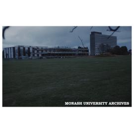 Administration building under construction, with Main Library and Menzies Building in background