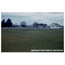 Administration Building, Library and Union under construction, Talbot school house in foreground