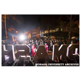 Law graduates celebrating with family and friends outside campus centre with (from right to left) Chancellor Alan Finkel, honorary graduate Michael Kirby, and Dean of Law Bryan Horrigan